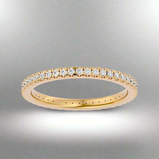 Gold ring with diamonds on a gray background