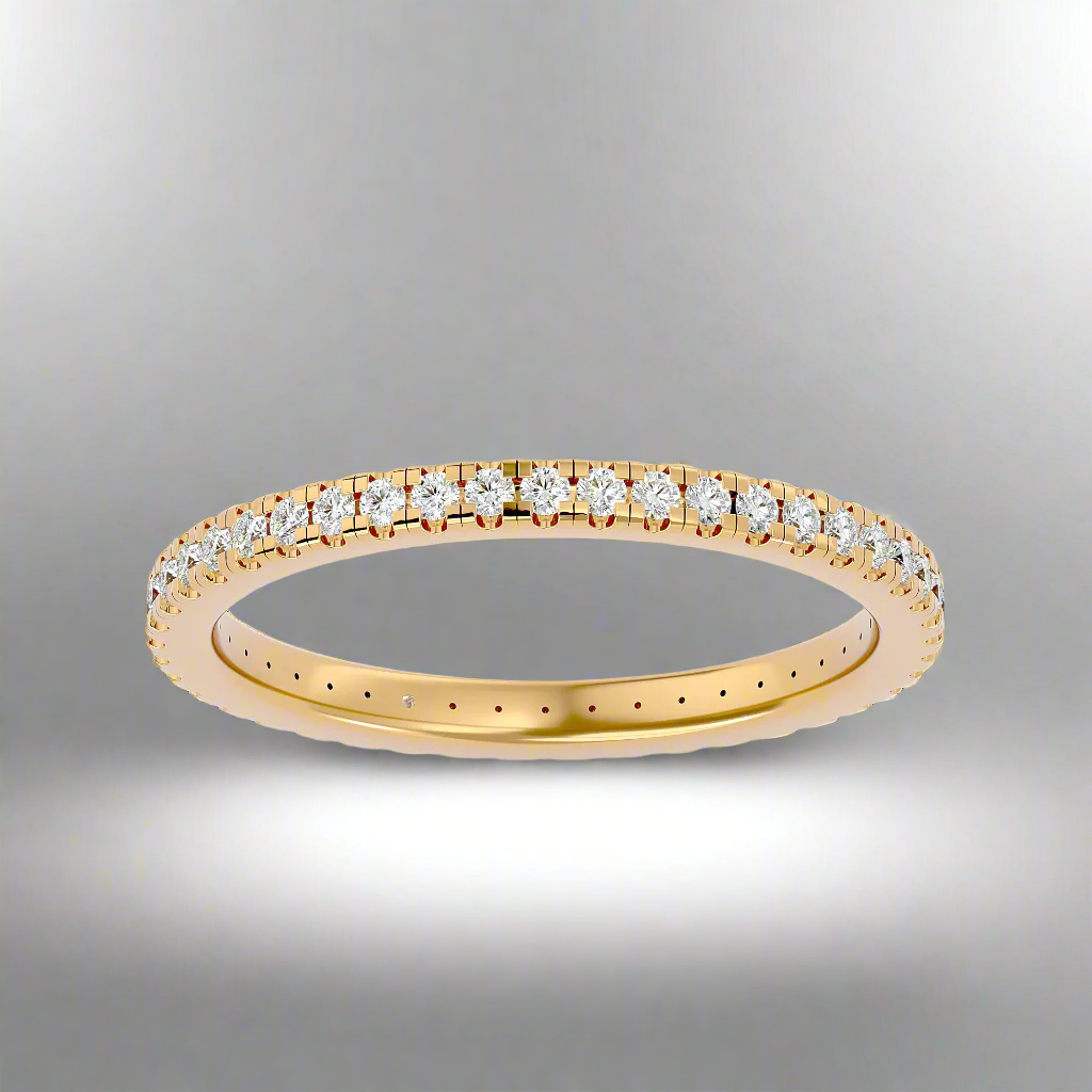 Gold ring with diamonds on a gray background