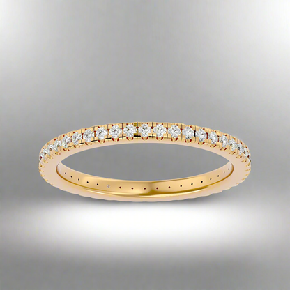 Gold ring with diamonds on a gray background